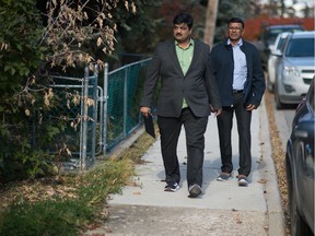 Regina-Lewvan NDP candidate Jigar Patel, left, walks between homes while doing some door knocking on the 2000 block of Wascana Street.