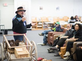 George Fayant teaches a group of people about the history of Red River Carts during a workshop held at the Regina Public Library's Central Branch.