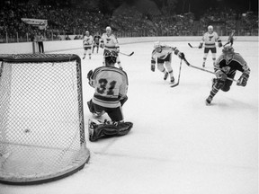 Marc Habscheid, right, of the Edmonton Oilers scores against St. Louis Blues goalie Rick Heinz in NHL pre-season action Sept. 30, 1981 at the Agridome.