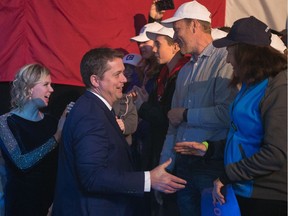 Conservative leader Andrew Scheer shakes hands with the crowd at the Conservative election-night headquarters in the International Trade Centre at Evraz Place in Regina.