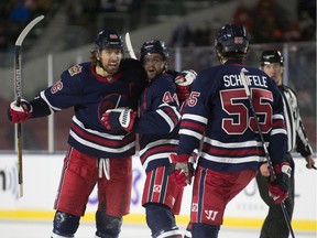 The Winnipeg Jets celebrate the tying goal during the NHL Heritage Classic at Mosaic Stadium in Regina.