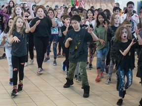 Students from Regina Catholic Schools perform the well-known dance to the popular song Thriller by the late Michael Jackson in the Regina International Airport's arrivals terminal on Wednesday.