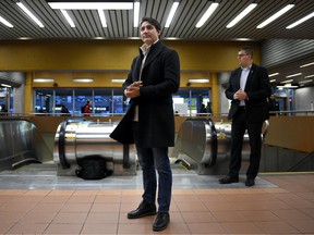 Prime Minister Justin Trudeau waits to greet commuters at a metro station in Montreal, Tuesday, Oct. 22, 2019.