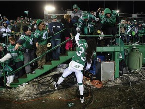 Defensive back Dwight Anderson celebrates with fans after the Saskatchewan Roughriders won the 2013 Grey Cup game on Taylor Field.