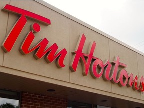 In this file photo taken on Aug. 27, 2014 the sign over a Tim Hortons coffee-and-donut shop is viewed in Magog, Quebec.