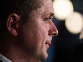 In this file photo taken on Sept. 17, 2018, Conservative leader Andrew Scheer listens to questions on Parliament Hill in Ottawa. Conservatives, if elected, would slash Canadian foreign aid by 25 per cent, or Can$1.5 billion (US$1.1 billion), Scheer announced on October 1, 2019.