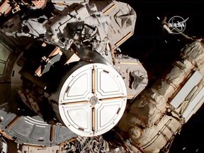 This grab of a handout video obtained from NASA on October 18, 2019 shows US astronauts Christina Koch and Jessica Meir during an action to replace a power controller outside the International Space Station (ISS). - US astronauts Christina Koch and Jessica Meir became the first all-female pairing to carry out a spacewalk on October 18, 2019, following a spacesuit flub earlier this year that caused the historic mission to be aborted. (Photo by HO / NASA / AFP) / RESTRICTED TO EDITORIAL USE - MANDATORY CREDIT "AFP PHOTO / NASA" - NO MARKETING - NO ADVERTISING CAMPAIGNS - DISTRIBUTED AS A SERVICE TO CLIENTS