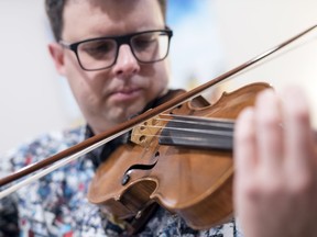 Regina Symphony Orchestra Concertmaster Christian Robinson plays his violin in his home in Regina.