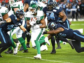 CP-Web. Saskatchewan Roughriders running back William Powell, center, is tackled by Toronto Argonauts defensive end Freddie Bishop III, right, during first half CFL football game action in Toronto on Saturday, September 28, 2019.