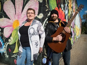 Donna Ritter, left, and Dustin Ritter stand against a mural outside of Ukrainian Co-op.