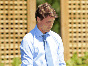 Prime Minister Justin Trudeau waits to be introduced before speaking about a watchdog's report that he breached ethics rules by trying to influence a corporate legal case regarding SNC-Lavalin, Aug. 14, 2019.