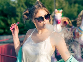 A young woman vaping. (Getty Images)