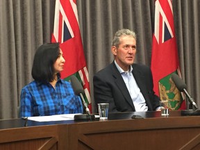 Jay Grewal, president and CEO of Manitoba Hydro (left) and Manitoba Premier Brian Pallister address a media conference at the Manitoba Legislature in Winnipeg on Sunday, Oct. 13, 2019. The Manitoba government has declared a provincial state of emergency for Manitoba Hydro to help deal with the aftermath of the major winter storm that swept a large area of the province.