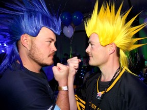 Brother and rivals Adam and Kris Farley pose for a photo at the Touchdown Manitoba Team Party as thousands of fans join the Grey Cup celebrations at the BMO Centre on Friday, November 22, 2019.