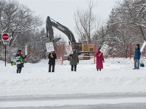 People stand protesting in front of the Brandt/CNIB construction site on Broad Street. BRANDON HARDER/ Regina Leader-Post