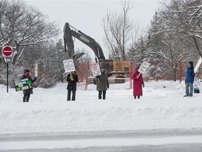 People stand protesting in front of the Brandt/CNIB construction site on Broad Street.