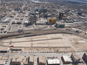 An aerial photo shows Regina's downtown and the railyard adjacent to Dewdney Avenue.