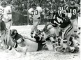 Saskatchewan Roughriders quarterback Gary Lane, 14, runs the ball against the Calgary Stampeders in the 1970 Western Conference final at a snow-swept Taylor Field. Roy Antal/Regina Leader-Post.