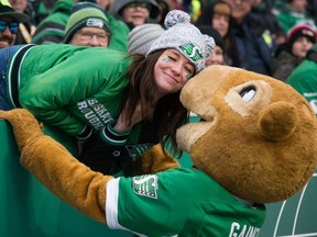 Gainer the Gopher kisses a Roughriders fan Saturday at Mosaic Stadium, where the Green and White defeated the Edmonton Eskimos 23-13 to clinch first place in the CFL's West Division.