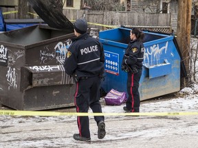 Saskatoon police responded on Nov. 8, 2019 to the discovery of an infant's body in a recycling bin the 400 block of Fifth Avenue North. Officers were called around 8:50 a.m. following a report of "an unknown problem." (Matt Smith / Saskatoon StarPhoenix)