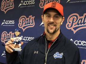 Former Regina Pats captain Colten Teubert poses with his bobblehead on Friday at the Brandt Centre.