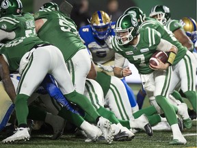 Saskatchewan Roughriders quarterback Cody Fajardo, right, was stuffed for a loss of one on this quarterback sneak late in the fourth quarter of Sunday's CFL West Division final against the visiting Winnipeg Blue Bombers.