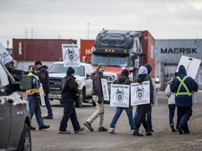 Employees strike in front of the CN rail yard in Saskatoon, delaying traffic in and out of the area, on Nov. 19, 2019.