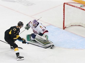 Donovan Buskey, shown making a save on Brandon Wheat Kings forward Ridly Greig, celebrated his first victory with the Regina Pats on Saturday.