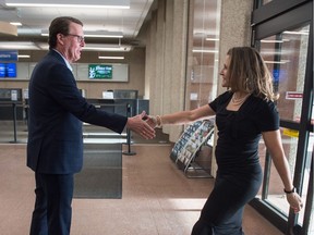 Regina Mayor Michael Fougere shakes hands with Canada's Deputy Prime Minister Chrystia Freeland at Regina City Hall in November 2019.