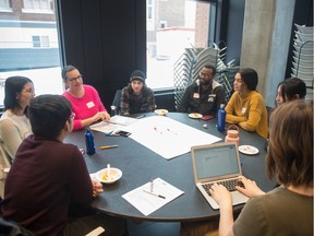 Participants conduct a discussion at a Youth Community Energy Forum held the the College Building on College Avenue.