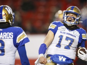 The Winnipeg Blue Bombers' Chris Streveler, right, celebrates his touchdown with fellow quarterback Zach Collaros during the fourth quarter of Sunday's CFL West Division semi-final against the host Calgary Stampeders. Winnipeg won 35-14 to earn a berth in Sunday's division final against the host Saskatchewan Roughriders.