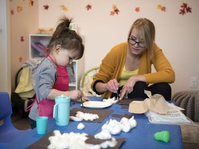 Elian Maertens, early childhood educator, works with Alanna Phillimore during a craft class at Brain Snacks Co.