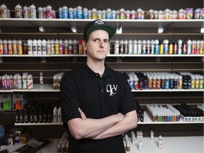 Mike Smider, owner of Queen City Vapes, stands near his flavour inventory.