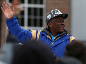 Winnipeg Blue Bombers defensive co-ordinator Richie Hall waves during the Grey Cup parade on Tuesday.