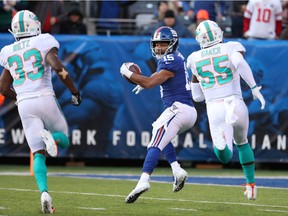 Golden Tate of the New York Giants begins to turn around and run backwards as he approaches the end zone Sunday against the Miami Dolphins.