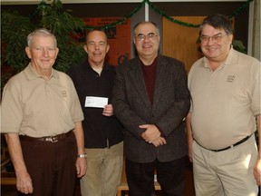 Bob Hughes, second from left, accepts a $4,000 donation to the Leader-Post Christmas Cheer Fund in 2005. Bob is flanked by Forbes McQueen, left, Will Chabun, second from right, and Don Punga.
