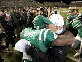 Saskatchewan Roughriders head coach Ken Miller, right, embraces quarterback Darian Durant after a 27-17 victory over the Calgary Stampeders in the CFL's 2009 West Division final at Taylor Field.