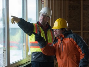 Paul Whelan, left, senior project manager for Westridge Construction, discusses the view with Nick Popowich in a building that is to be the future home for people with intellectual disabilities on Mitchinson Way in Regina, Saskatchewan on December 6, 2019. Popowich is one of the home's future residents.