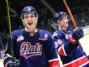 Kyle Walker, left, and Riley Krane of the Regina Pats celebrate a 3-2 win over the Red Deer Rebels at the Brandt Centre on Saturday.
