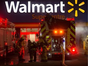Firefighters work to manage a fire in the Walmart store on Rochdale Boulevard in Regina, Saskatchewan on Dec. 10, 2019.