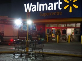 Firefighters work to manage a fire in the Walmart store on Rochdale Boulevard in Regina, Saskatchewan on Dec. 10, 2019.