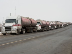 Fuel trucks wait along the side of Fleet Street in Regina, Saskatchewan on Dec. 12, 2019. Unifor workers, who are currently locked out of the Co-op Refinery Complex, are disrupting the flow of traffic in and out of the complex.