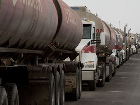 Fuel trucks wait along the side of Fleet Street in Regina, Saskatchewan on Dec. 12, 2019. Unifor workers, who are currently locked out of the Co-op Refinery Complex, are disrupting the flow of traffic in and out of the complex.