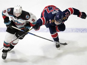 The Kelowna Rockets' Mark Liwiski (9) and Nikita Sedov (27) of the Regina Pats race for the loose puck in WHL action at the Brandt Centre in Regina on Friday.