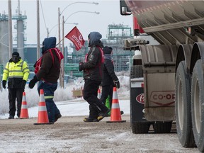 Members of Unifor 594, currently locked out of the Co-op Refinery, walk the picket line at a gate to the complex on Fleet Street in Regina, Saskatchewan on Dec 14, 2019.