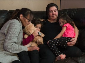 Family members of homicide victim Keenan Toto sit in their family home in Regina, Saskatchewan on Dec. 19, 2019. From left is mother Trenna Toto, daughter Zulay Toto, wife Jacqueline Kequahtooway and daughter Xadia Toto. The 23-year-old's death was the city's 9th homicide of 2019.