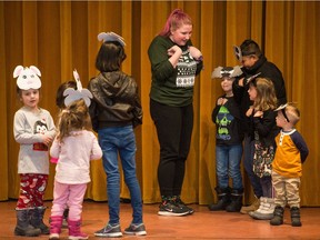 Hannah Dove, centre, gallery interpreter for the Royal Saskatchewan Museum, directs children on stage as part of the 'Twas the Night Before Hibernation play in the Museum's auditorium in its main building on Albert Street in Regina, Saskatchewan on Dec. 28, 2019.