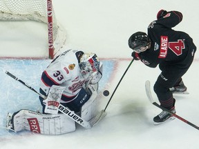 Regina Pats goaltender Max Paddock stops a shot by the Moose Jaw Warriors' Eric Alarie in WHL action on Saturday at the Brandt Centre.