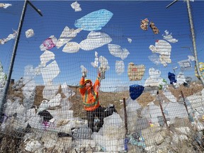 Dustin Caulderwood works on spring cleanup along the south fence line at the City of Regina's landfill in April 2015.
