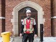 John O'Dwyer, Ledcor superintendent on the Darke Hall and College Building restoration projects, stands in front of an archway on the outside of the College Building.